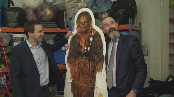 Global News Europe Bureau Chief and Paul Cowan pose with a cardboard cutout of Chewbacca that was found on the Tube.