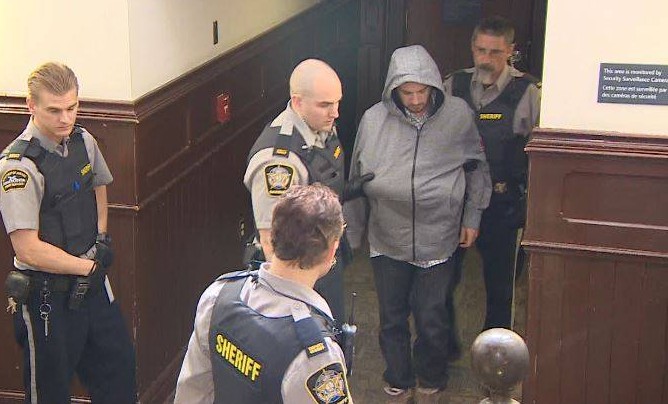 Nicholas Butcher is escorted into Halifax provincial court on Tuesday, April 12, 2016. 