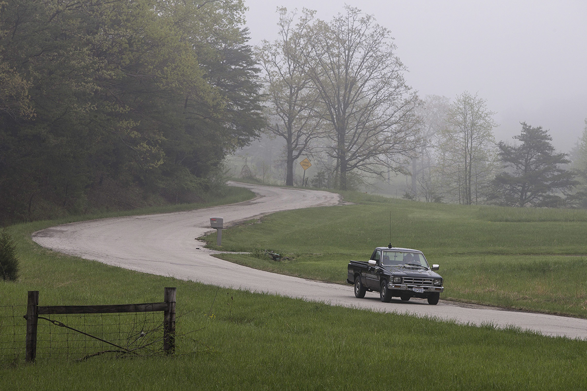 Leonard Manley, father and grandfather of several murder victims, drives down Union Hill Road towards a roadblock at the outer perimeter of a crime scene, Wednesday, April 27, 2016, in Piketon, Ohio. 
