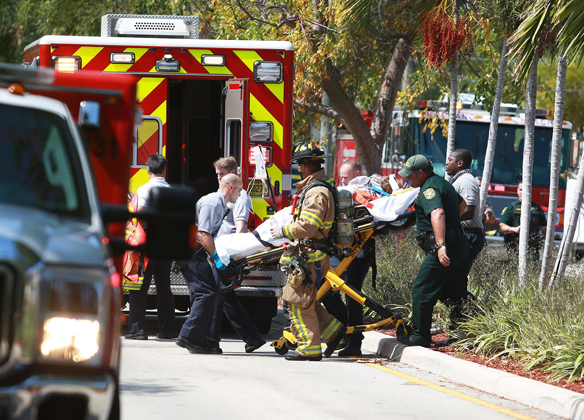 A person is transported to the hospital after a plane crashed into a house in Pompano Beach, Fla., Monday, April 25, 2016.