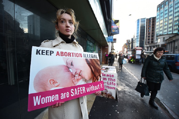 FILE PHOTO: A pro-life activist stands outside an abortion clinic.