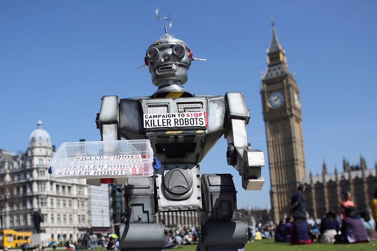 A robot distributes promotional literature calling for a ban on fully autonomous weapons in Parliament Square on April 23, 2013 in London, England. 