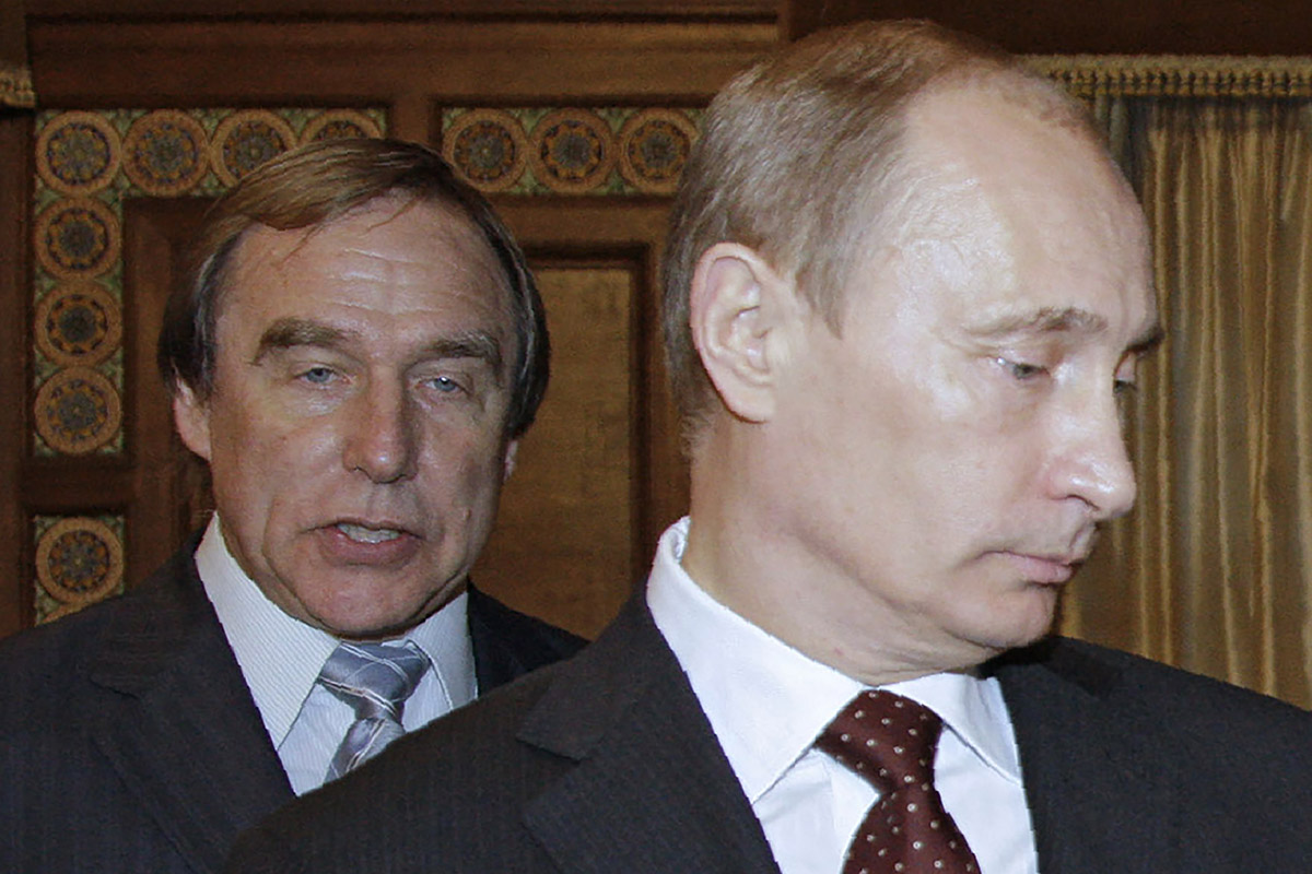 A picture taken on November 21, 2009 shows then Russia's Prime Minister Vladimir Putin (front) and Russian cellist Sergei Roldugin.