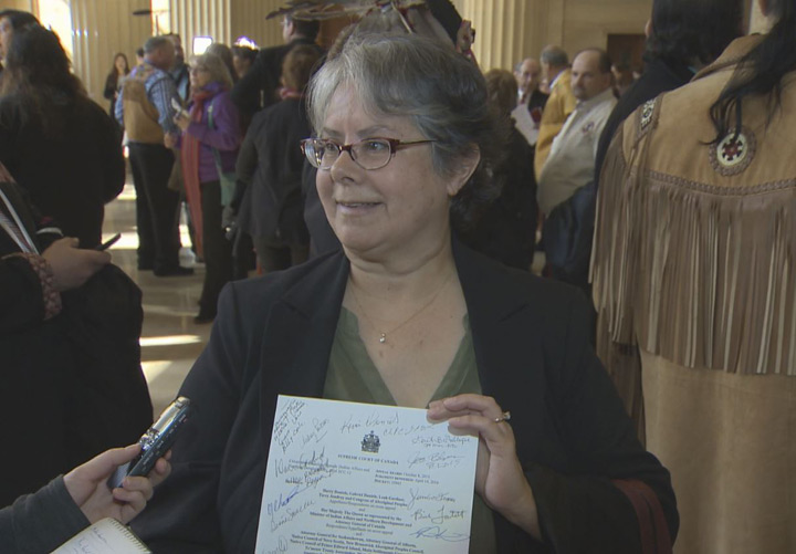 Gail Gallupe, president of the McMurray Métis, shows off her signed Supreme Court decision.
