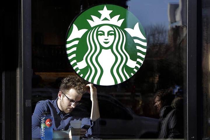 In this Jan. 11, 2016, photo, a man sits inside a Starbucks, in New York. 
