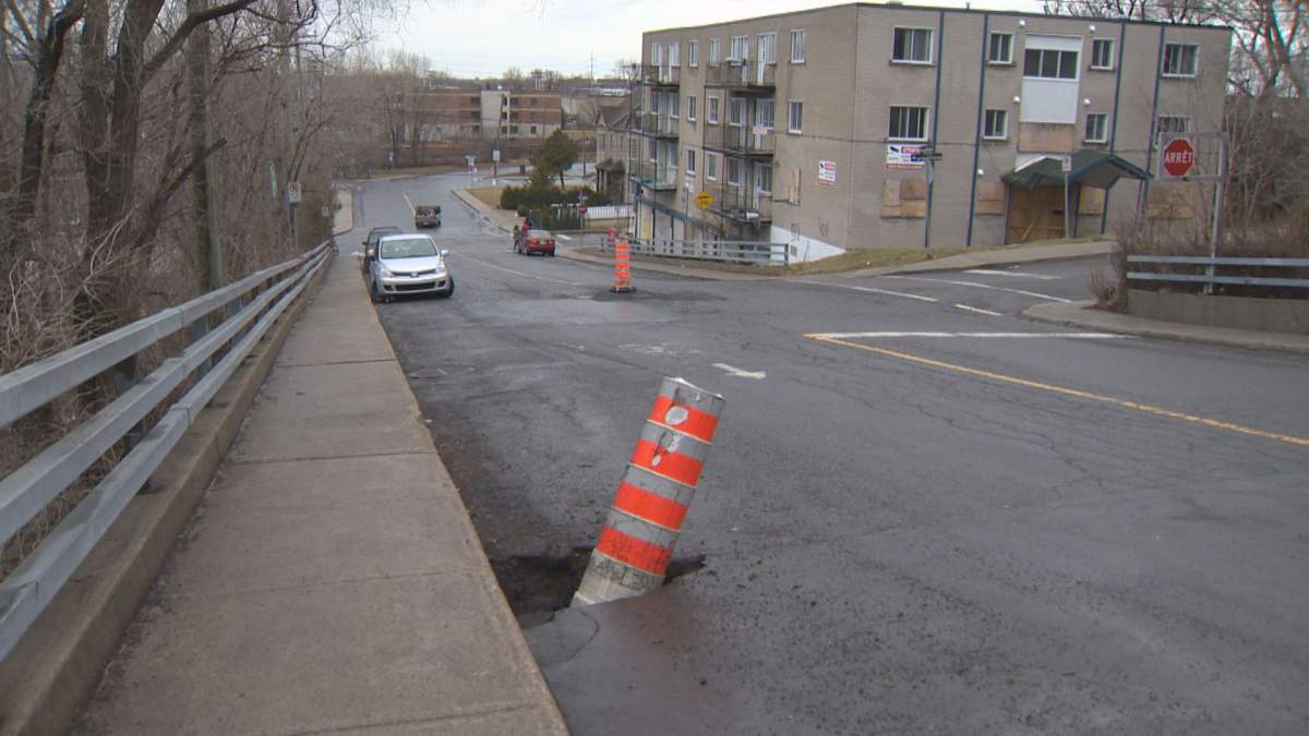 Orange cones cover sinkholes and potholes in Montreal, Friday, April 1, 2016.