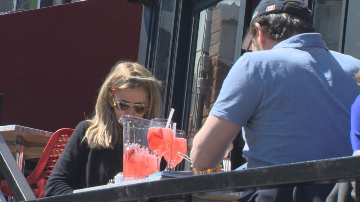 Montrealers enjoy a drink outside.