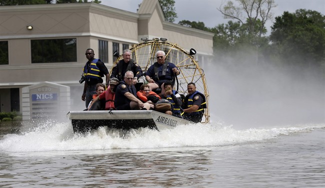 Residents are evacuated by airboat from their flooded neighborhood, Tuesday, April 19, 2016, in Spring, Texas. 