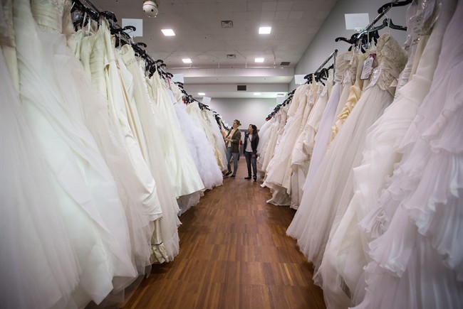 Women browse wedding dresses for sale at the Original Bridal Swap at the Croatian Cultural Centre in Vancouver, B.C., on Sunday April 3, 2016.