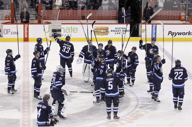 The Winnipeg Jets salute fans after their victory over the Minnesota Wild in their final home game of the 2015-2016 season.