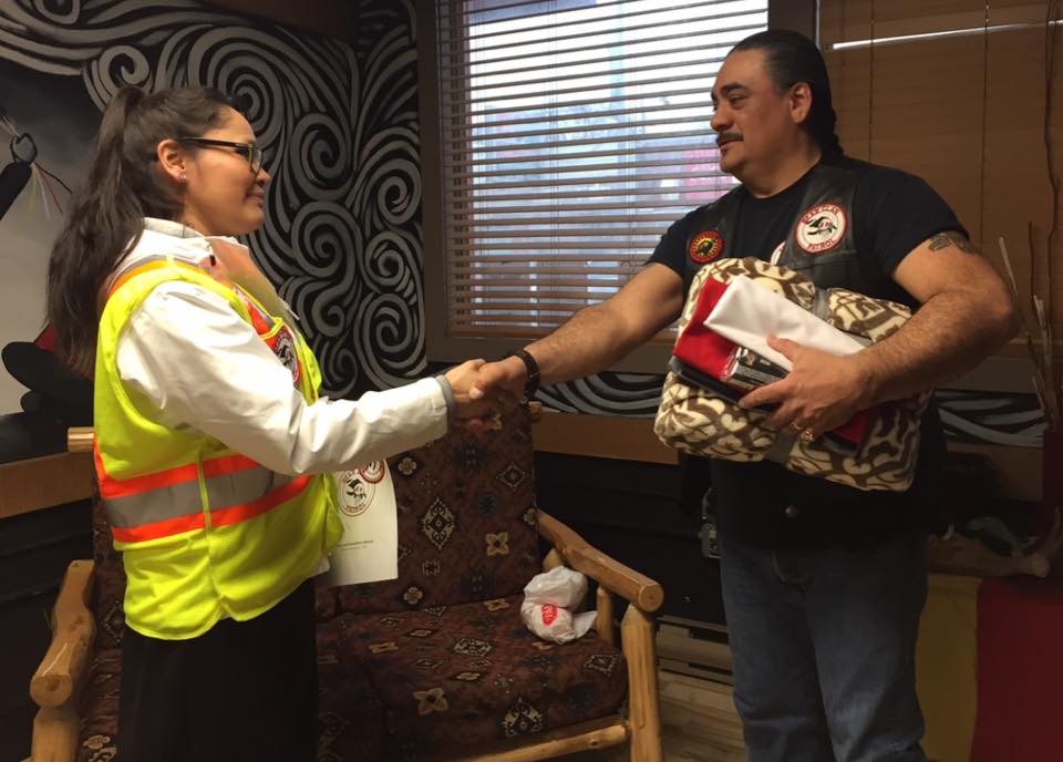 Shawna Oochoo (left) meets with James Favel of the Winnipeg-based Bear Clan Patrol.