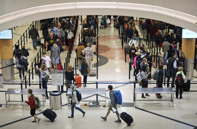 FILE - In this Nov. 25, 2015 file photo, travelers wait to go through a security checkpoint at Hartsfield–Jackson Atlanta International Airport in Atlanta. (AP Photo/David Goldman, File).