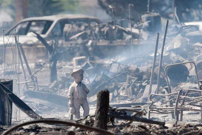 The smoldering remains of houses in Slave Lake, Alta., are seen in a May 16, 2011 file photo.