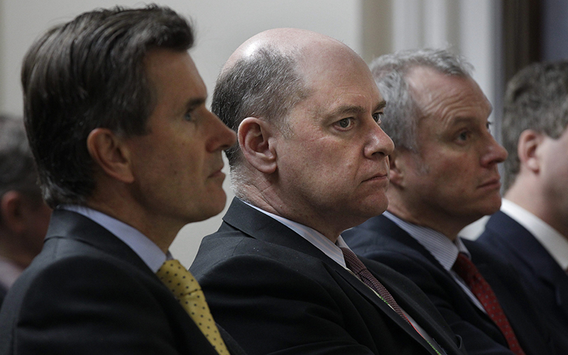 Former MI5 director-general Jonathan Evans, centre, and former MI6 chief John Sawers (L) listen with another official in the front row of the audience during a speech by Britain's Foreign Secretary William Hague at the Foreign Office.
