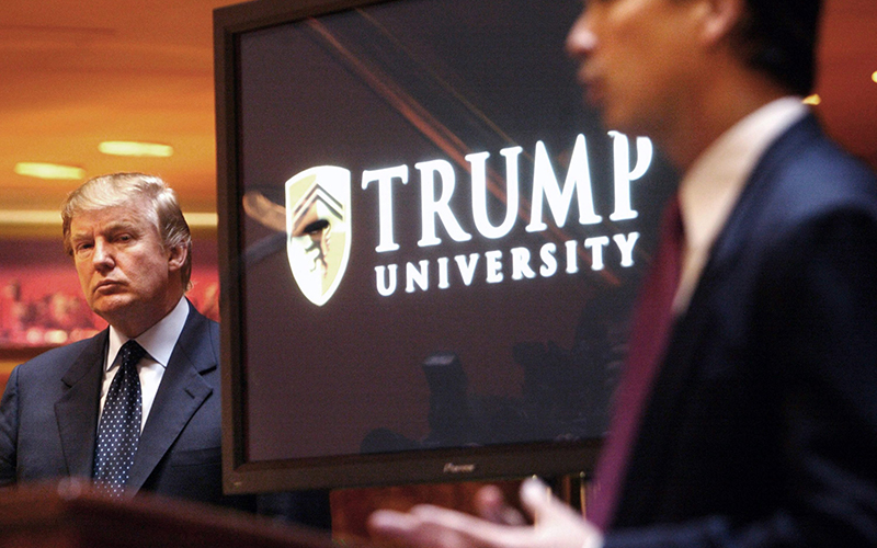 Donald Trump listens as he is introduced at a news conference in New York where he announced the establishment of Trump University.