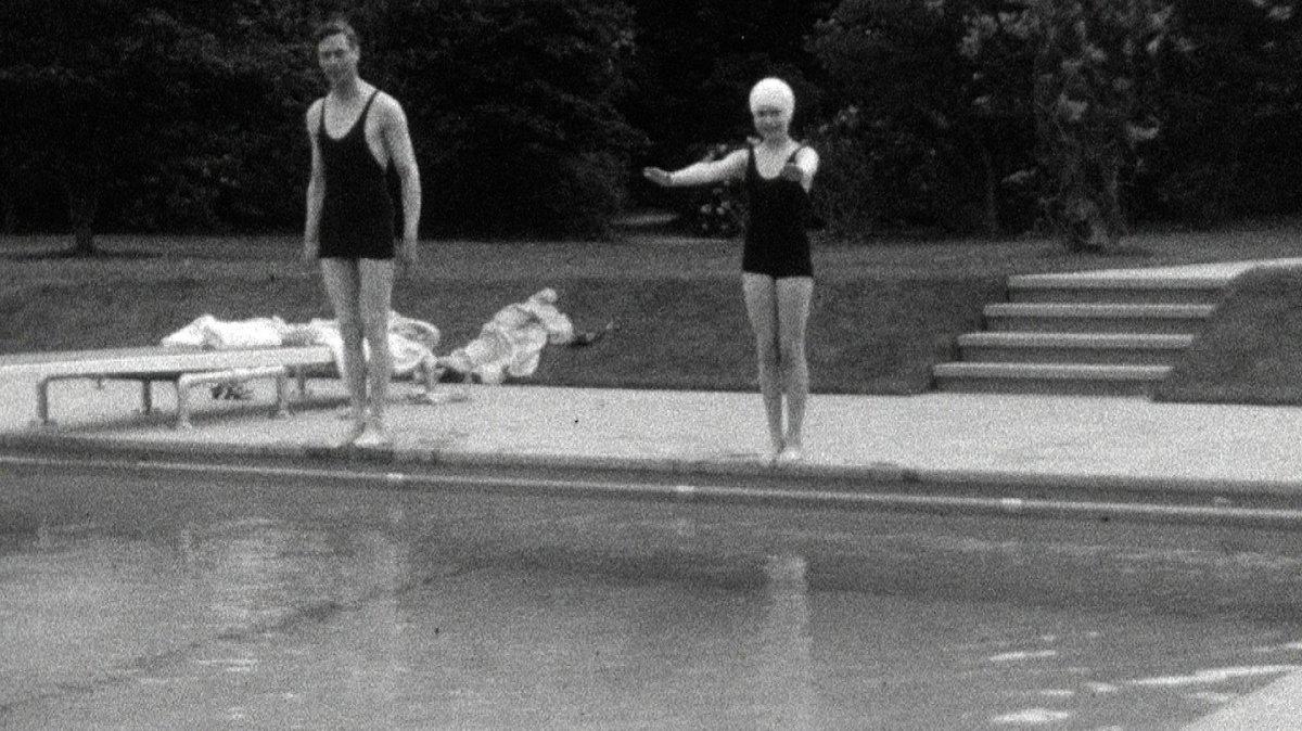 This undated handout photo provided by HM The Queen shows the then Princess Elizabeth swimming with her father, King George VI in Britain. Rare footage of Britain's Queen Elizabeth has been shared to celebrate her 90th birthday.   