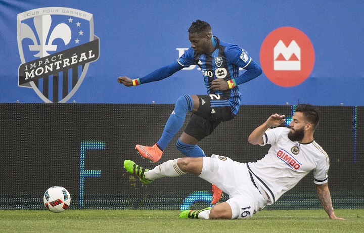 Montreal Impact's Ambroise Oyongo (2) challenges Philadelphia Union's Richard Marquez (16) during first half MLS soccer action in Montreal, Saturday, May 14, 2016.