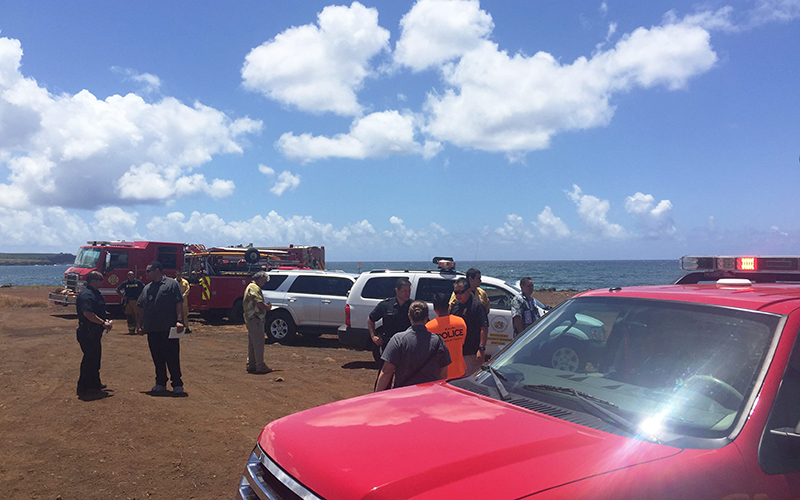 This photo provided by Kauai County shows emergency response vehicles near the site of a plane crash in Hanapepe, Hawaii, on Monday, May 23, 2016. All five people aboard a small plane died in a fiery crash on Kauai, officials said.