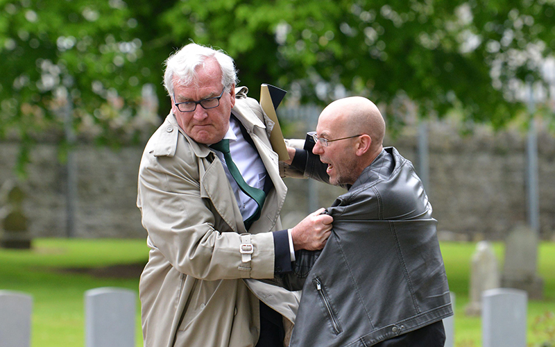 Canadian Ambassador to Ireland, Kevin Vickers wrestles with a protester who disrupted a state ceremony to remember the British soldiers who died during the Easter Rising 1916 at Grangegorman Military Cemetery.