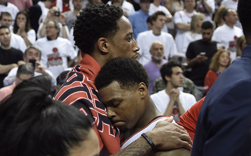 Toronto Raptors guard DeMar DeRozan, left, hugs teammate Kyle Lowry after the Eastern Conference final NBA playoff basketball game against the Cleveland Cavaliers in Toronto on Friday, May 27, 2016. 