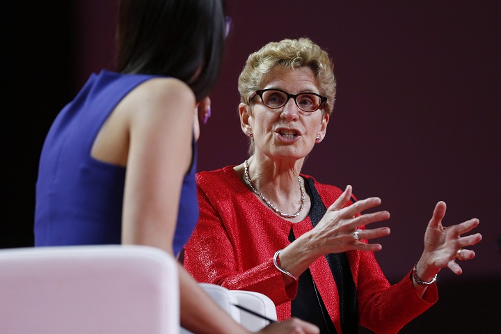 Ontario Premier Kathleen Wynne, right, speaks to Liz Plank onstage at the 2016 Liberal Biennial Convention in Winnipeg, Saturday, May 28, 2016. 