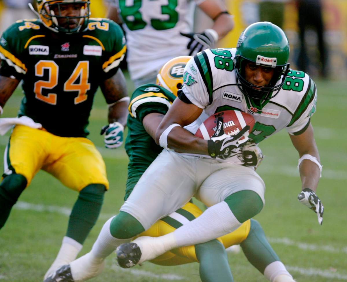 Saskatchewan Roughriders Matt Dominguez is tackled by Edmonton Eskimos Omarr Morgan during first half CFL action in Edmonton Friday July 20, 2007.