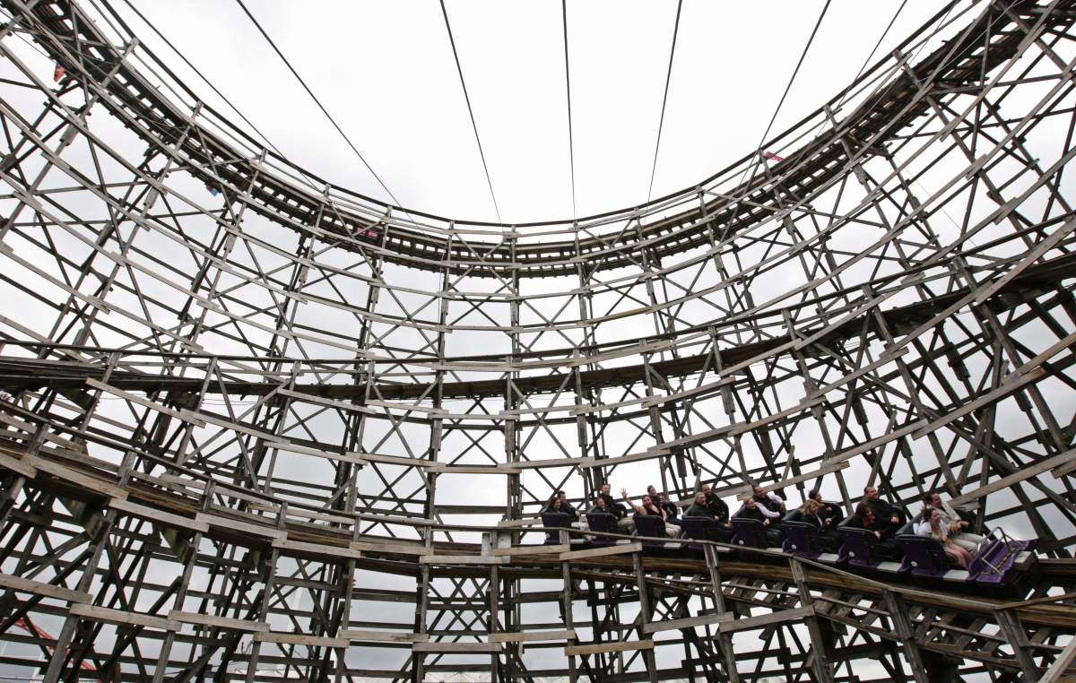 People ride the Playland Wooden Coaster during a celebration of its 50th birthday in Vancouver, B.C., on Tuesday June 17, 2008.