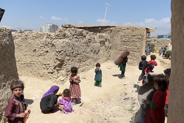 Internally-displaced Afghan children gather at a refugee camp in Kabul on May 31, 2016. 
