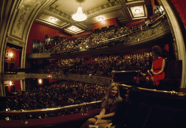 People await the start of a show at the Royal Alexandra Theatre in Toronto. (Photo by Robert Madden/National Geographic/Getty Images).