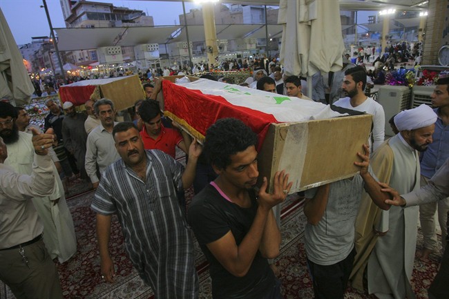 Mourners carry the Iraqi flag-draped coffins of bomb victims, Murtada Mohammed, 26, and his brother Sadiq Mohammed, 22, during their funeral procession at the holy shrine of Imam Ali in Najaf, 100 miles (160 kilometers) south of Baghdad, Iraq, Wednesday, May 11, 2016. An explosives-laden car bomb ripped through a commercial area in a predominantly Shiite neighborhood of Baghdad on Wednesday, killing and wounding dozens of civilians, a police official said.
