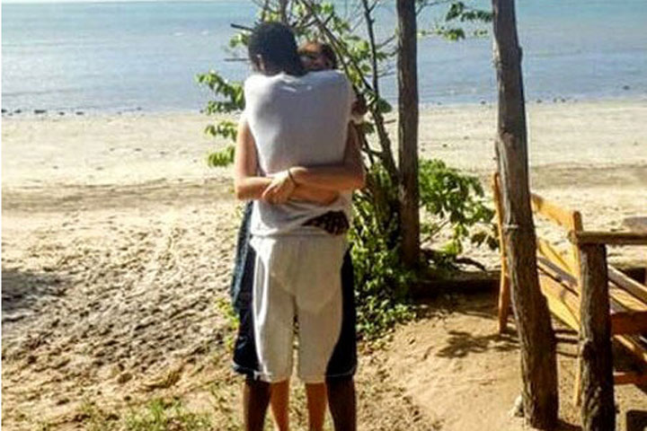 This photo of a couple hugging on the beach has gone viral. Whose feet are in front?.