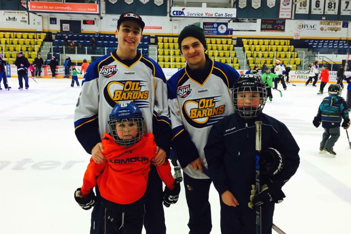 Oil Barons players pose with billet families.