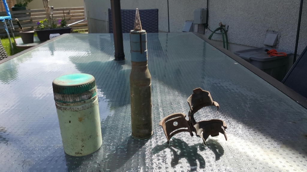 A smoke grenade, 25 mm round and a clip were found in an Acadia backyard Sunday.
