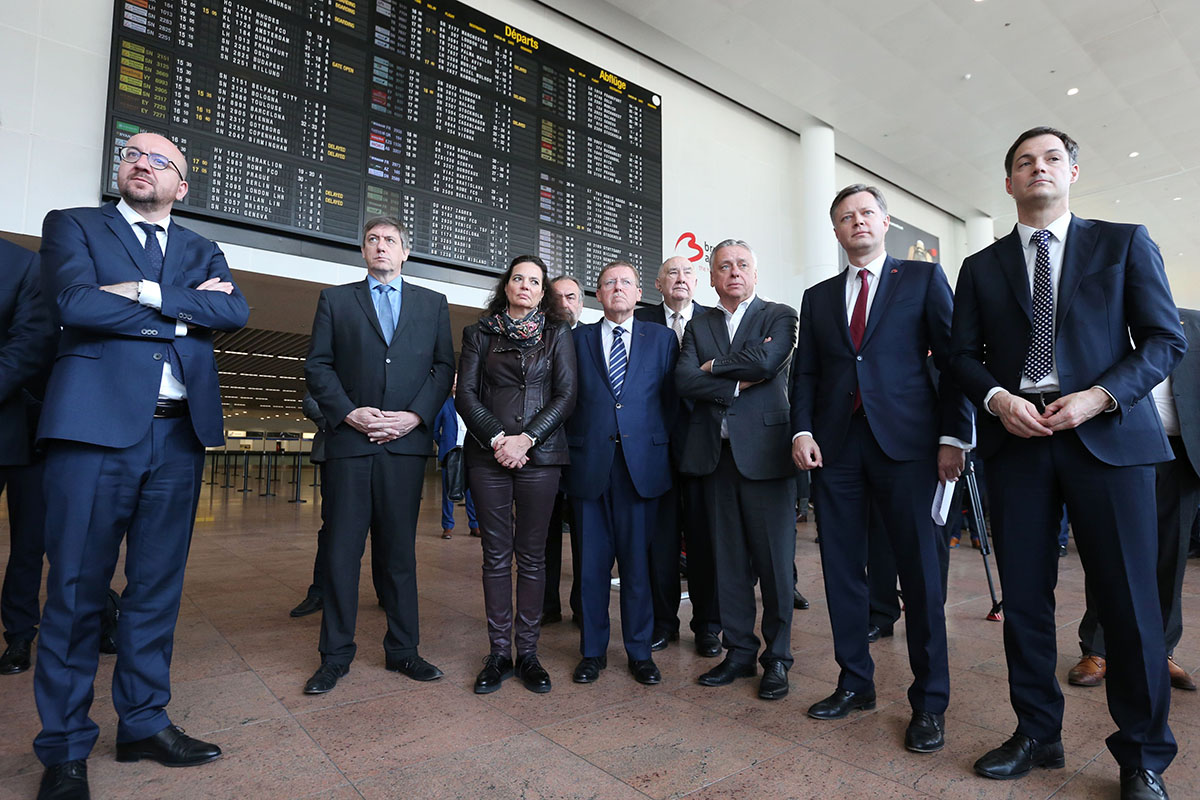(L-R) Belgian Prime Minister Charles Michel, Interior Minister Jan Jambon, Senate chairwoman Christine Defraigne, Chamber chairman N-VA's Siegfried Bracke, Open Vld's Patrick Dewael, Brussels Airport CEO Arnaud Feist and Minister of Cooperation Development, Digital Agenda, Telecom and Postal services Alexander De Croo pose on May 1, 2016 at Zaventem airport in Brussels during the opening ceremony of the departure hall, closed since the March 22 attacks. 