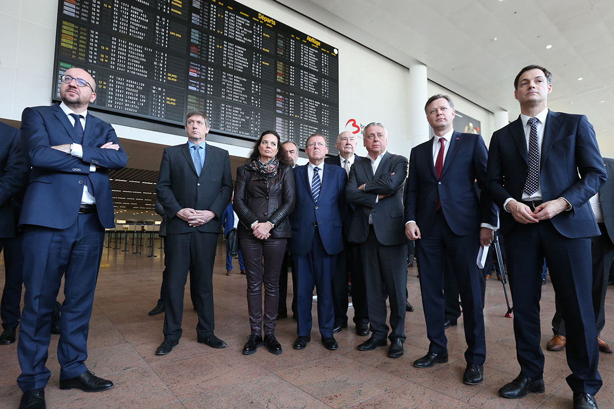 (L-R) Belgian Prime Minister Charles Michel, Interior Minister Jan Jambon, Senate chairwoman Christine Defraigne, Chamber chairman N-VA's Siegfried Bracke, Open Vld's Patrick Dewael, Brussels Airport CEO Arnaud Feist and Minister of Cooperation Development, Digital Agenda, Telecom and Postal services Alexander De Croo pose on May 1, 2016 at Zaventem airport in Brussels during the opening ceremony of the departure hall, closed since the March 22 attacks. 