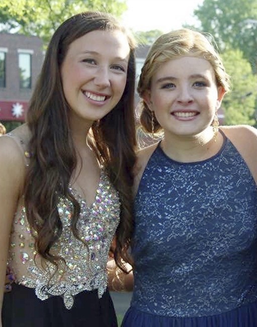 Bonnie Hourican, her daughter Lauren Hourican, left, poses with Catherine Malatesta before the junior prom at Arlington High School in Arlington, Mass. After Catherine died from a rare cancer on Aug. 2, 2015, some of Catherine's friends, including Lauren, decided to wear her gown to their own proms in 2016 in Catherine's honor.