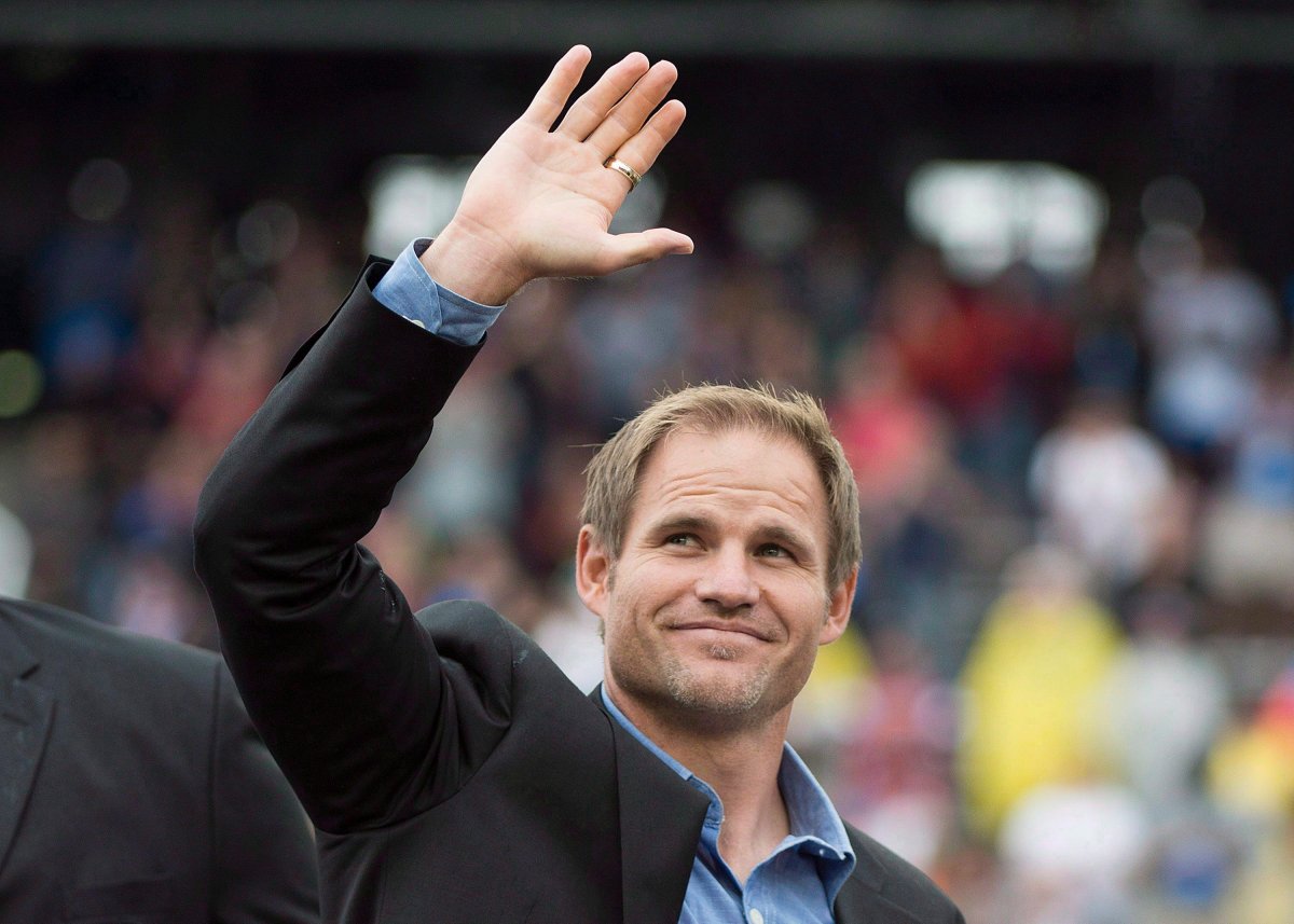 Former Alouettes receiver Ben Cahoon waves to fans after being inducted into the CFL Hall of Fame during a half-time ceremony as the Montreal Alouettes take on the Calgary Stampeders in Montreal, Sunday, September 21, 2014.