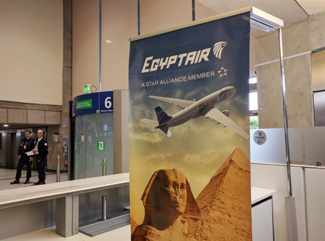 Airport security staff stand near the EgyptAir counter at Charles de Gaulle Airport outside of Paris, France, Thursday, May 19, 2016. EgyptAir said a flight from Paris to Cairo disappeared from radar early Thursday morning.
