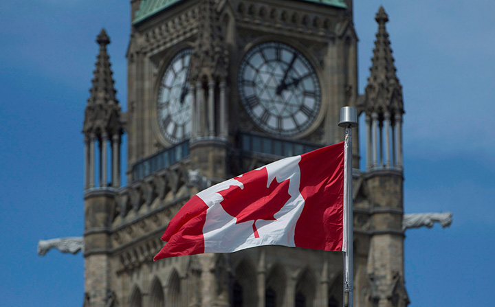 The Maple Leaf flies in front of the Peace tower on Parliament Hill Friday May 6, 2016 in Ottawa. 