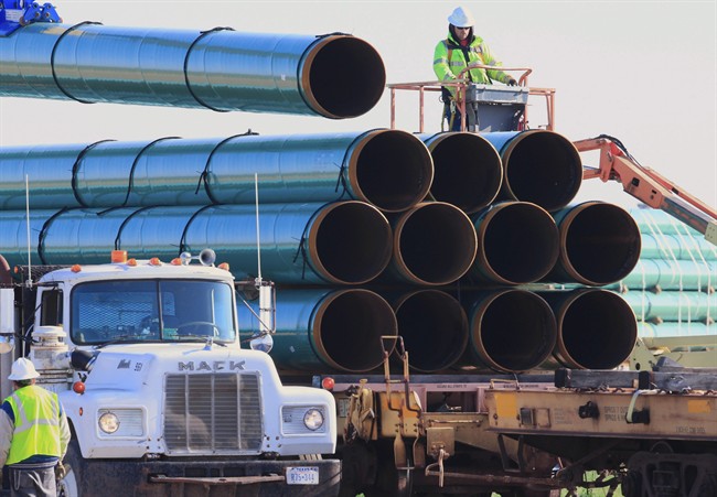 FILE - In this May 9, 2015, file photo, workers unload pipes for the proposed Dakota Access oil pipeline that would stretch from the Bakken oil fields in North Dakota to Illinois.