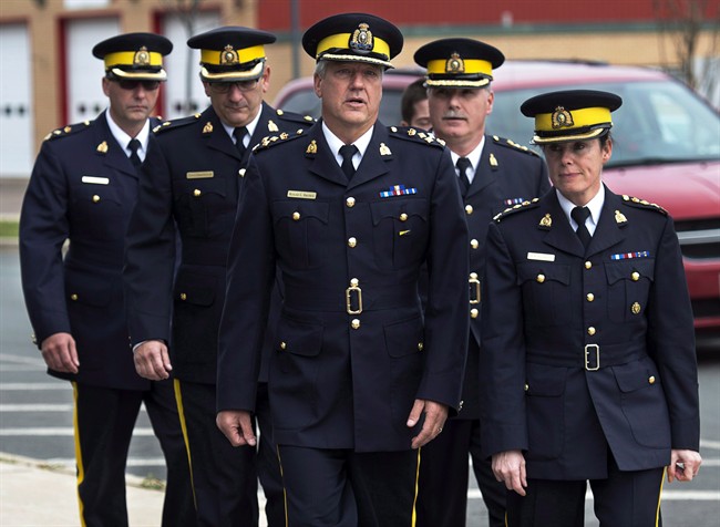 A group of senior RCMP officers, led by Assistant Commissioner Roger Brown, centre, head of the RCMP in New Brunswick, arrives at Moncton Law Courts for the sentencing for Justin Bourque in Moncton, N.B., in an October 31, 2014, file photo. 
