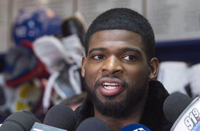 Montreal Canadiens defenceman P.K. Subban, right, talks with reporters at the team training facility on April 11, 2016 in Brossard, Que.