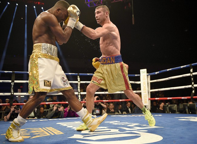 Lucian Bute, right, hits Badou Jack with a left during a boxing bout early Sunday, May 1, 2016, in Washington. Montreal boxer Lucian Bute says he is "surprised and saddened" to learn he had failed a doping test after his super middleweight title bout against Badou Jack. The World Boxing Council said Thursday that the D.C. Boxing and Wrestling commission revealed it found the banned substance Ostarine.