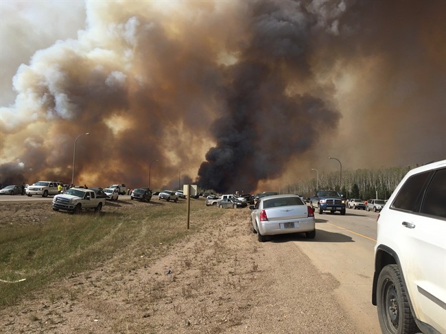 Abandoned vehicles litter Highway 63, south of Fort McMurray, Alta., as residents fled the wildfire engulfing the city on Tuesday, May 2, 2016.