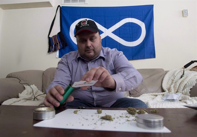 Clayton Goodwin prepares medicinal marijuana at his apartment in Ottawa, Friday March 20, 2015. 