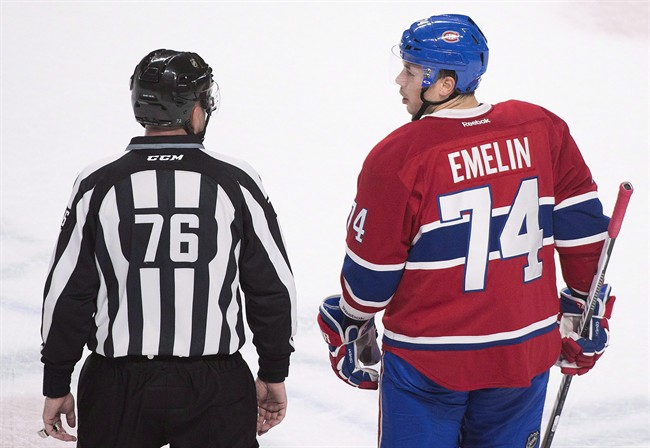 Montreal Canadiens' defender Alexei Emelin talks with linesman Michel Cormier after he was given a game misconduct during first period NHL hockey action against the Columbus Blue Jackets, in Montreal, on Dec. 1, 2015. Russia added Emelin of the Montreal Canadiens to their final 23-man roster for the World Cup of Hockey. THE CANADIAN PRESS/Graham Hughes.