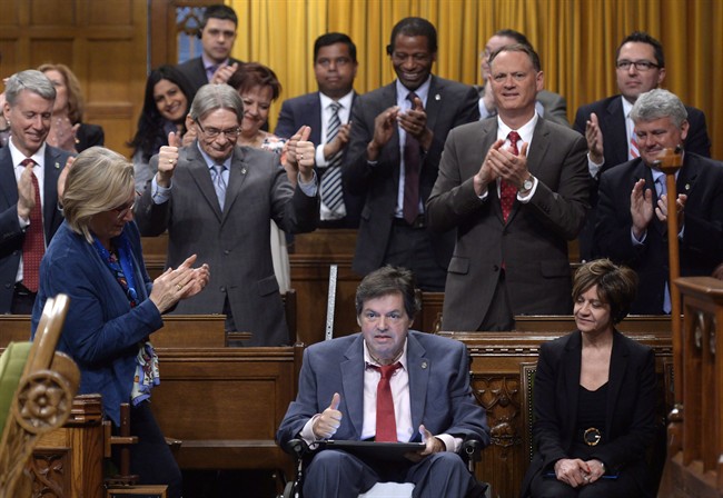 Ottawa-Vanier MP Mauril Belanger, who lives with ALS (also known as Lou Gherig's disease) uses a tablet with text-to-speech program to defend his proposed changes to neutralize gender in the lyrics to "O Canada" in the House of Commons on Parliament Hill in Ottawa on Friday, May 6, 2016.