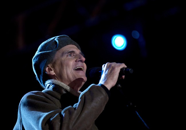 Singer James Taylor performs for President Barack Obama and the First Family during the annual National Christmas Tree Lighting on the Ellipse, Thursday, Dec. 6, 2012, in Washington. 