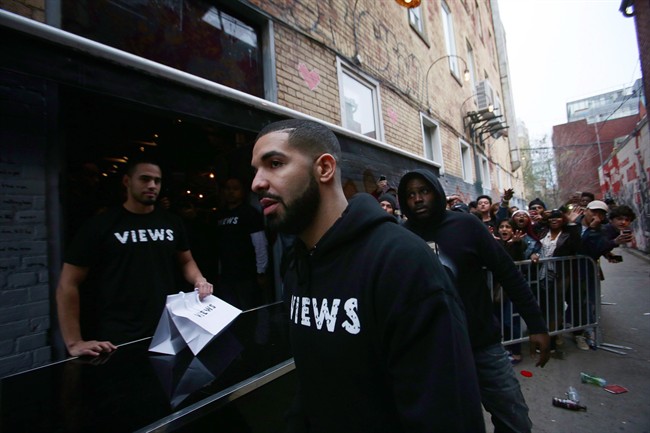 Toronto rapper Drake leaves a Queen St. West pop up shop where he was handing out T-shirts to promote his upcoming album in Toronto in this April 24, 2016, file photo. The Toronto-born rapper has added another raft of dates to his North American run, including shows in Edmonton and Montreal as well as more dates in Toronto. 