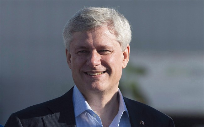 Conservative Leader Stephen Harper smiles as he arrives in Toronto on Oct. 11, 2015.